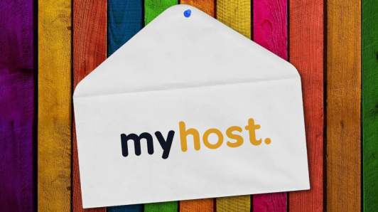 A paper envelope pinned onto a colourful wooden wall, with the MyHost logo printed on the envelope.